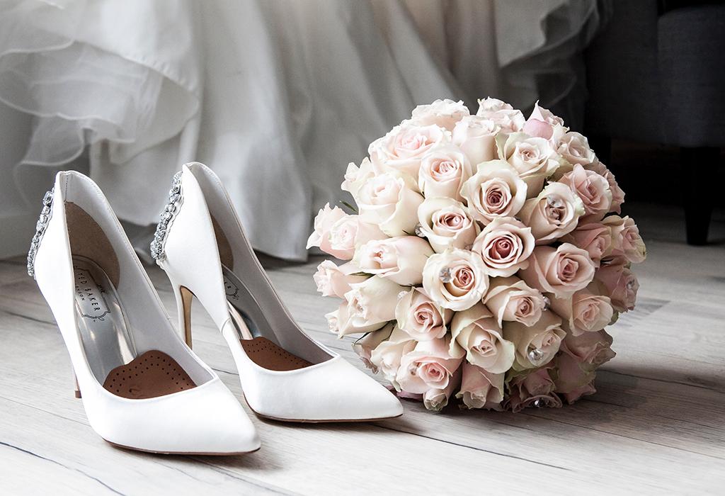 white wedding heels and flowers