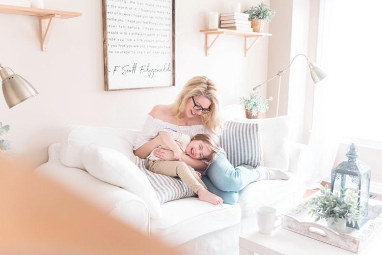 mom and kid playing on a sofa