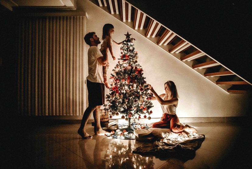 a family and Christmas tree in a house