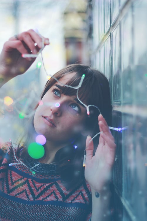 women holding string light